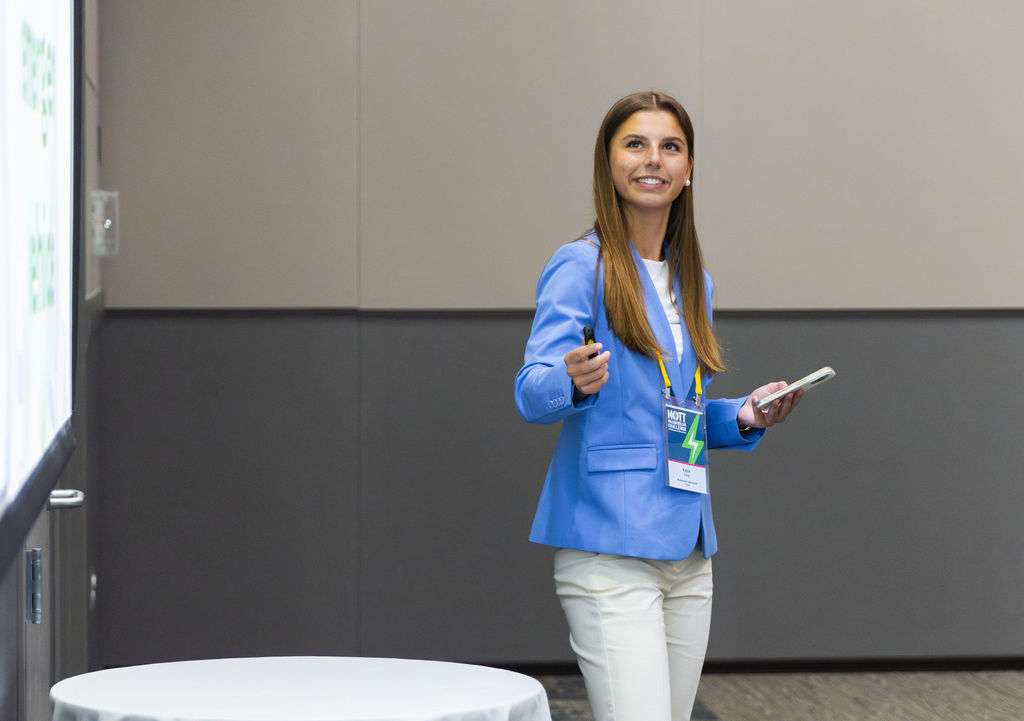 Student uses a clicker to change slides during a presentation